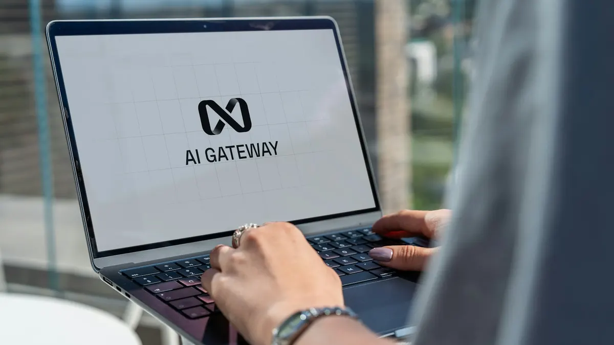 Close-up of a person's hands typing on a laptop displaying an AI product interface