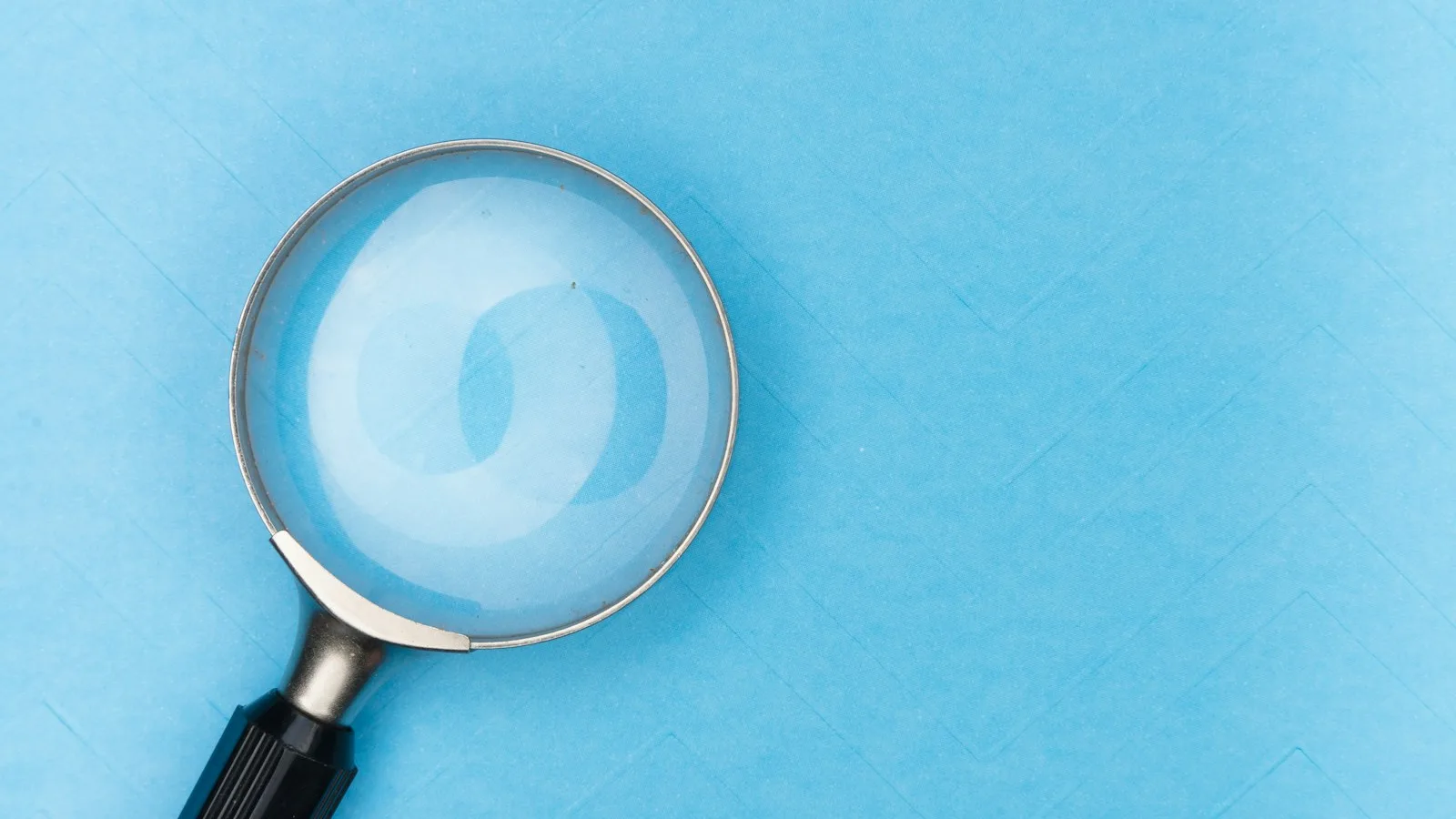 A search bar on a laptop screen with a magnifying glass icon